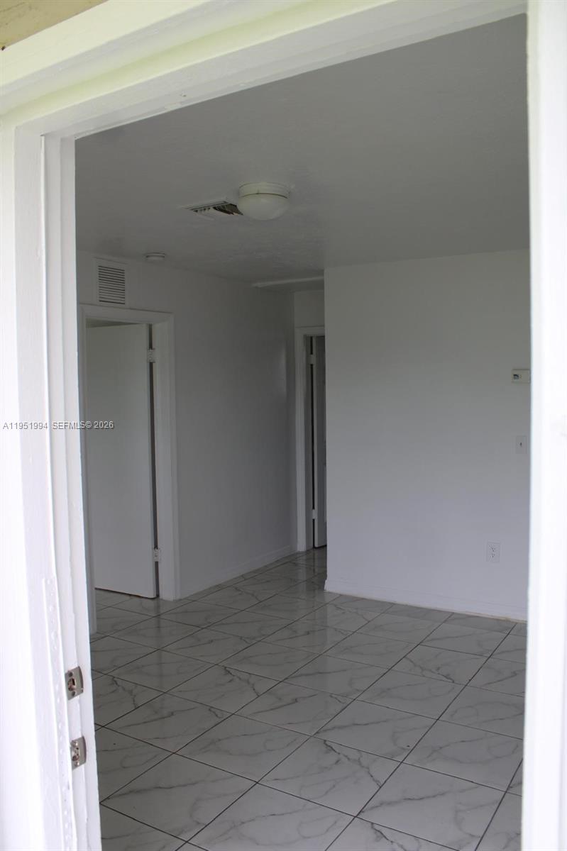 11535 Southwest 224th Street, Unit 2 Miami, FL 33170 - Photo 20 of 22 an empty room with a bench