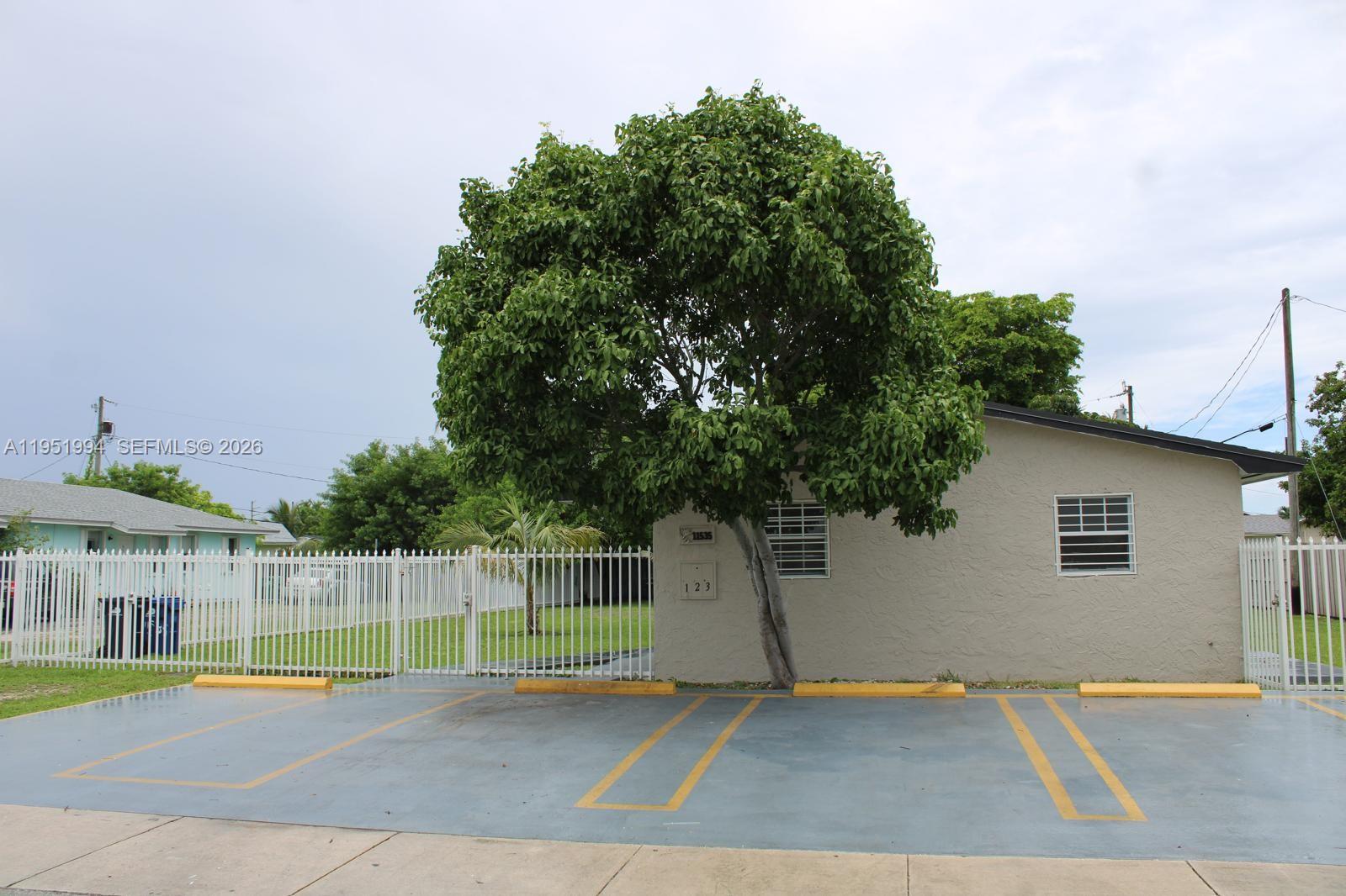 11535 Southwest 224th Street, Unit 2 Miami, FL 33170 - Photo 2 of 22 a view of a backyard with a plants and trees