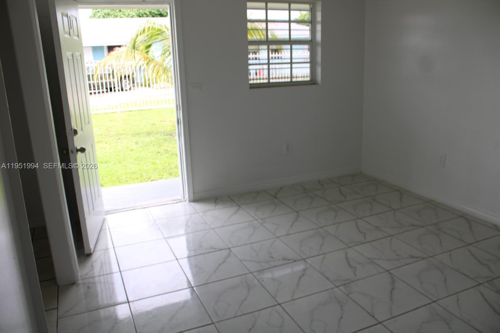 11535 Southwest 224th Street, Unit 2 Miami, FL 33170 - Photo 21 of 22 a view of an empty room and a window