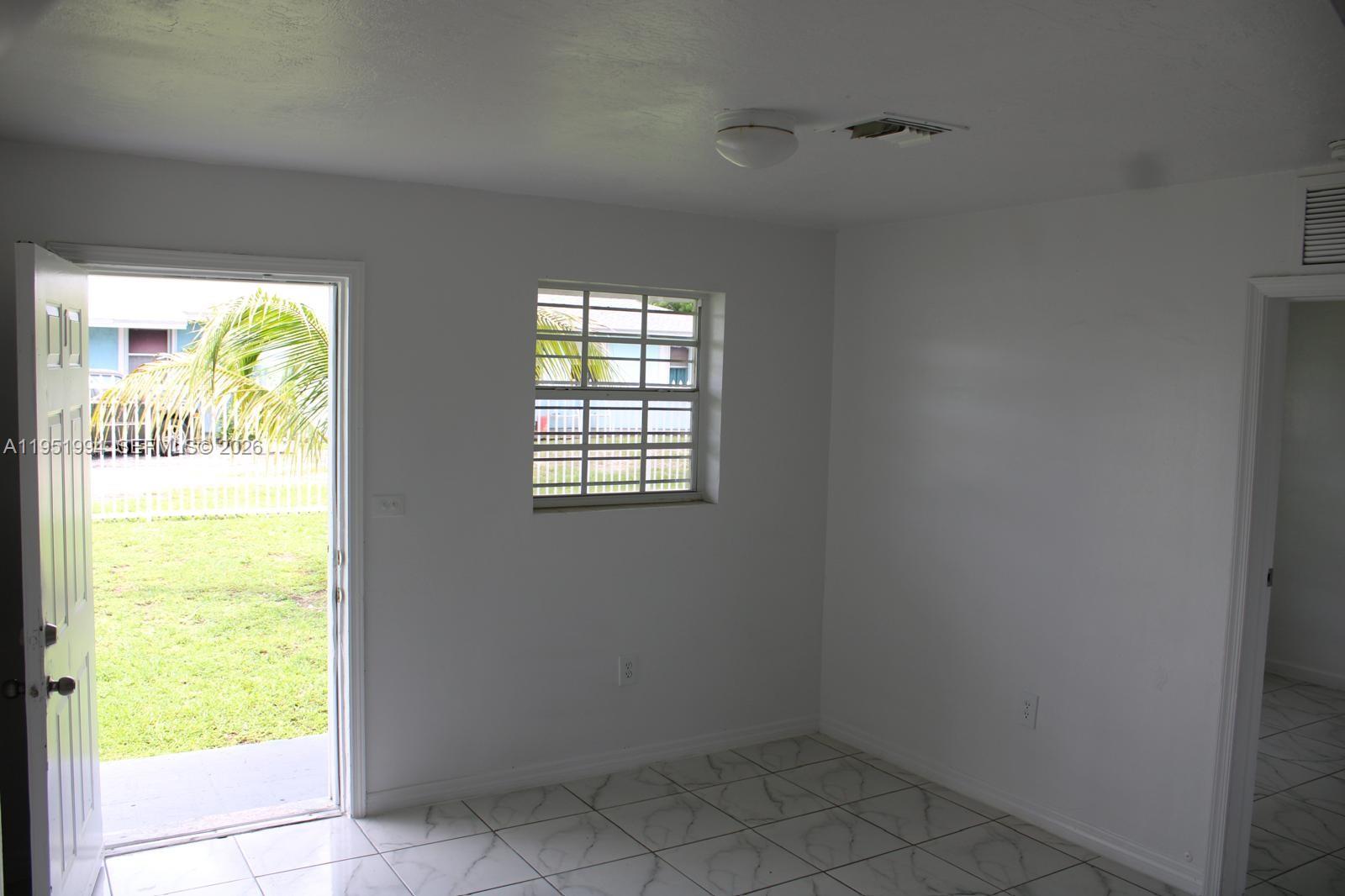 11535 Southwest 224th Street, Unit 2 Miami, FL 33170 - Photo 22 of 22 a view of an empty room and a window