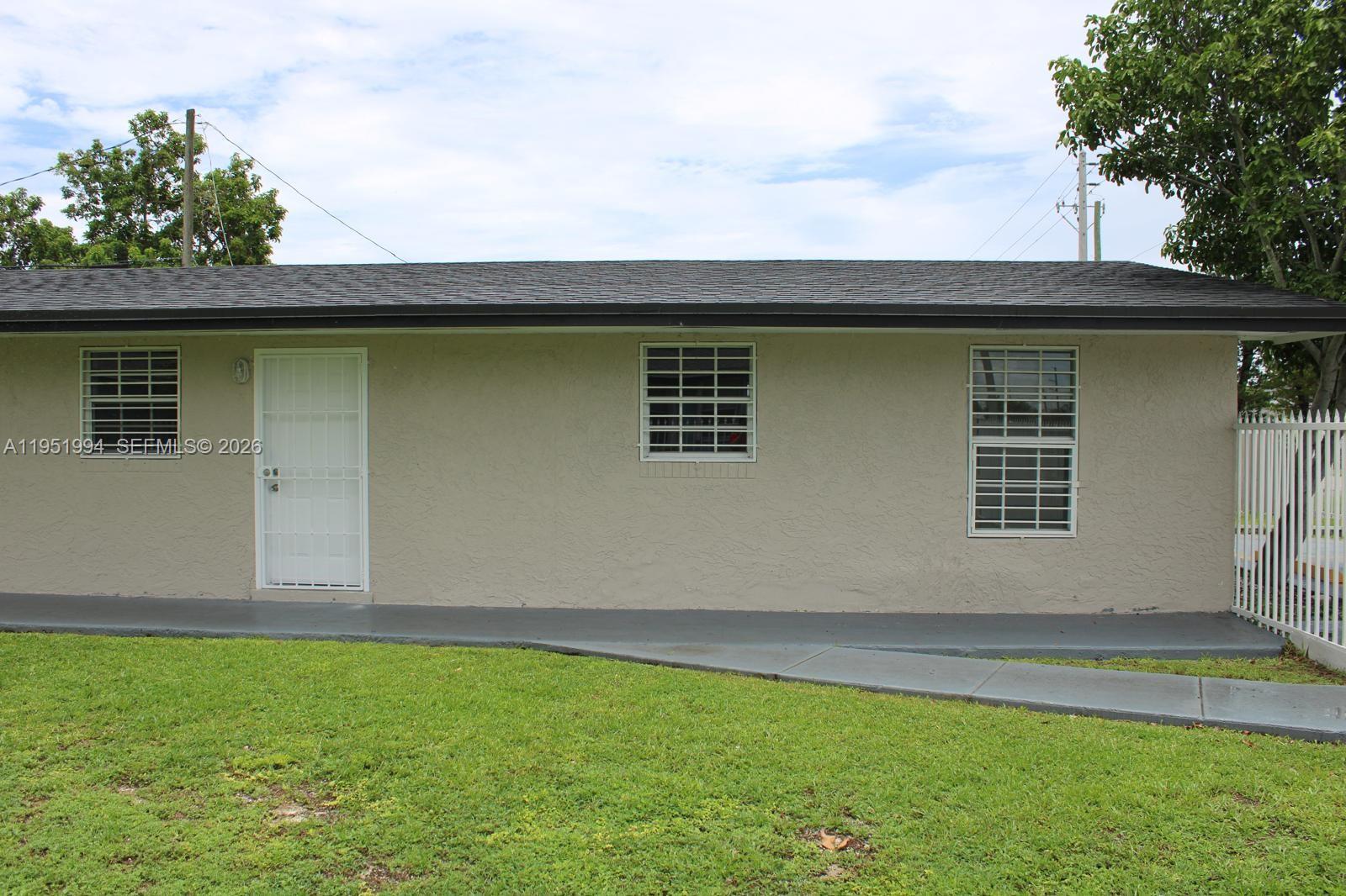11535 Southwest 224th Street, Unit 2 Miami, FL 33170 - Photo 3 of 22 a front view of a house with garden