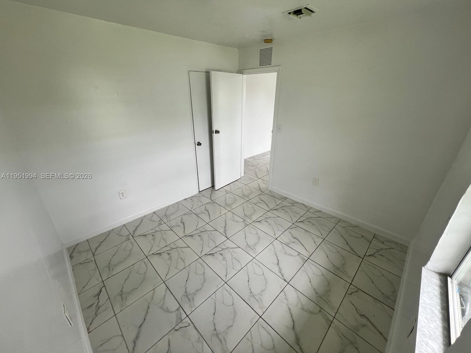 11535 Southwest 224th Street, Unit 2 Miami, FL 33170 - Photo 5 of 22 a view of a room with racks on the wall