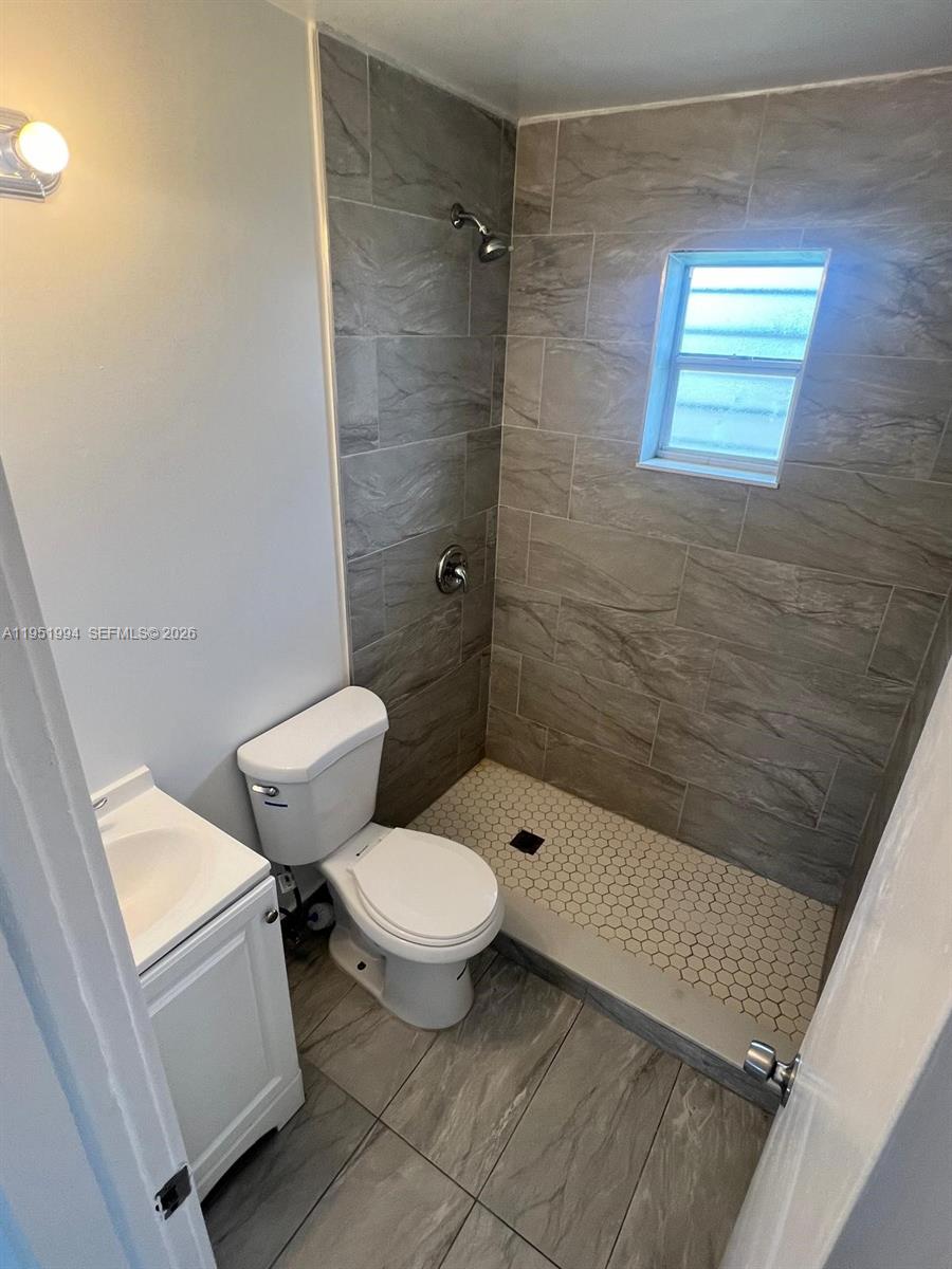 11535 Southwest 224th Street, Unit 2 Miami, FL 33170 - Photo 7 of 22 a bathroom with a toilet a sink and bathtub