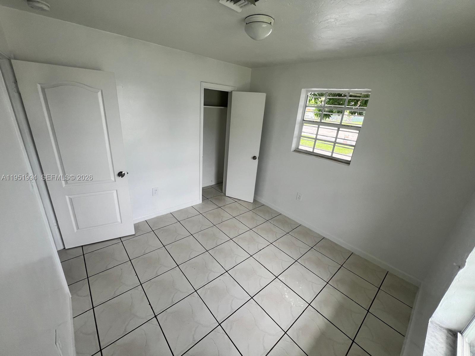 11535 Southwest 224th Street, Unit 2 Miami, FL 33170 - Photo 9 of 22 a view of an empty room and window