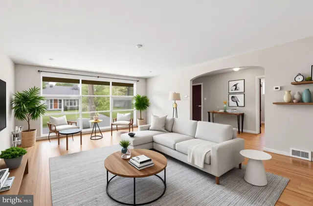 a view of a livingroom with wooden floor and a fireplace