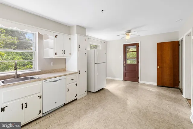 a view of a room with wooden floor and a bathroom