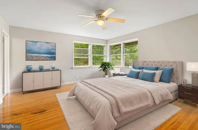 a bathroom with a sink a toilet a mirror and shower