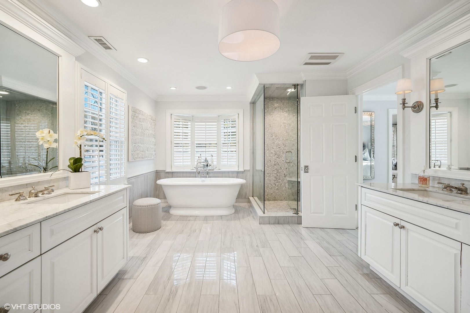 72 Woodley Road Winnetka, IL 60093 - Photo 38 of 65 a large bathroom with a double vanity sink a toilet a a mirror and shower