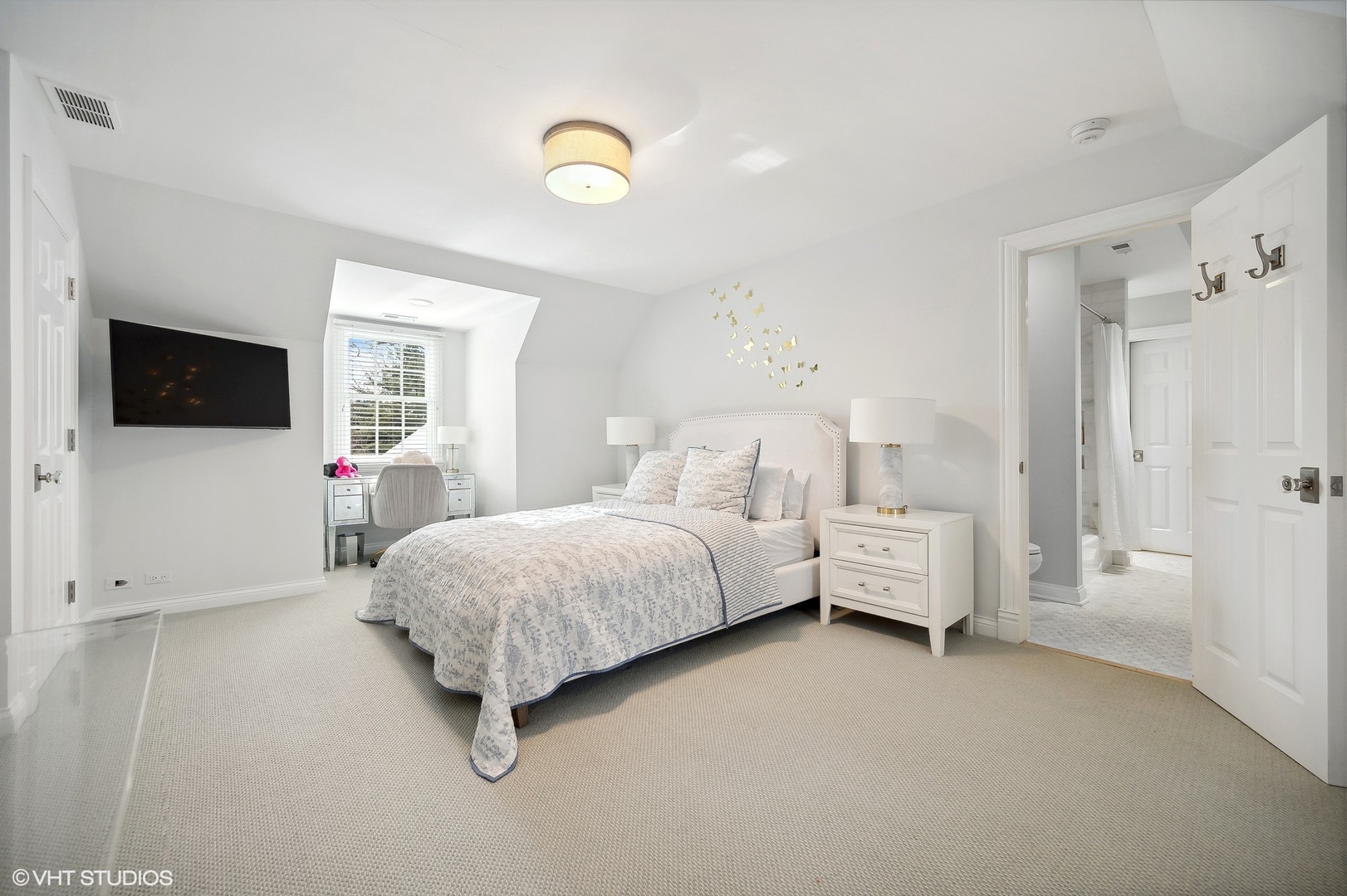 72 Woodley Road Winnetka, IL 60093 - Photo 52 of 65 a spacious bedroom with a bed and a flat screen tv