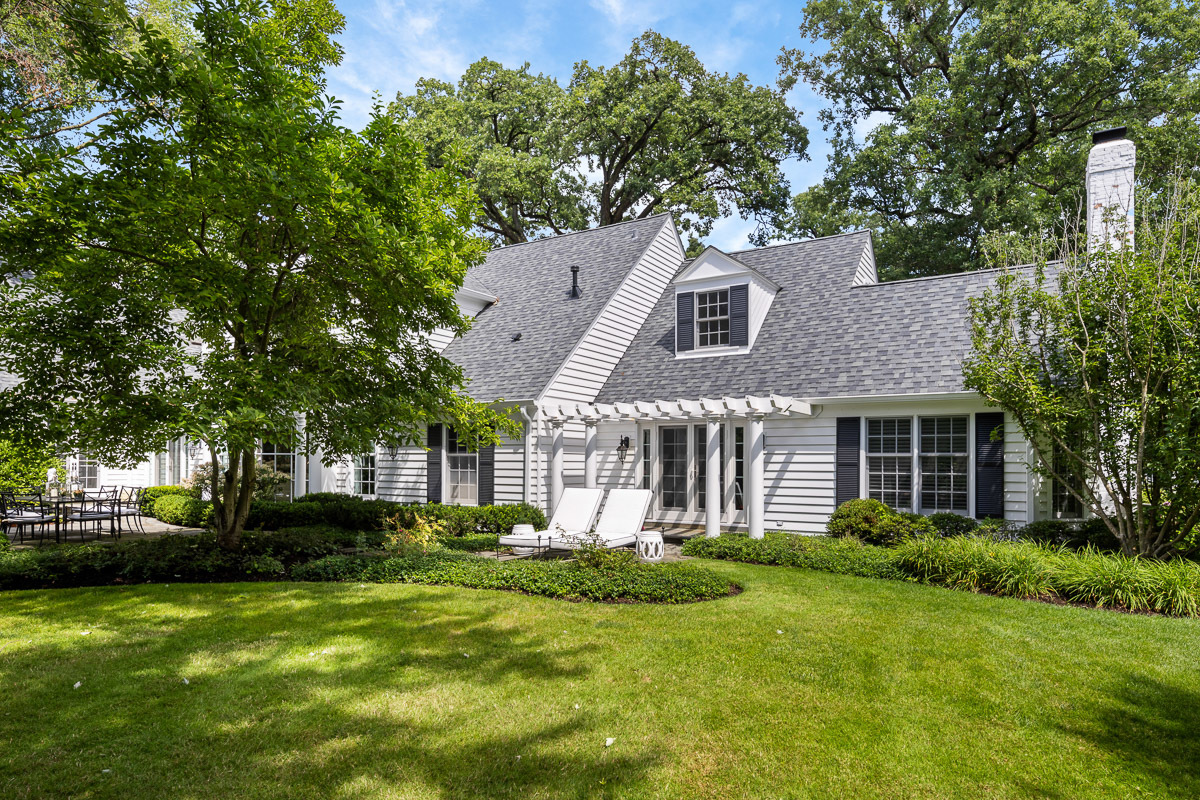 72 Woodley Road Winnetka, IL 60093 - Photo 7 of 9 a front view of a house with a garden