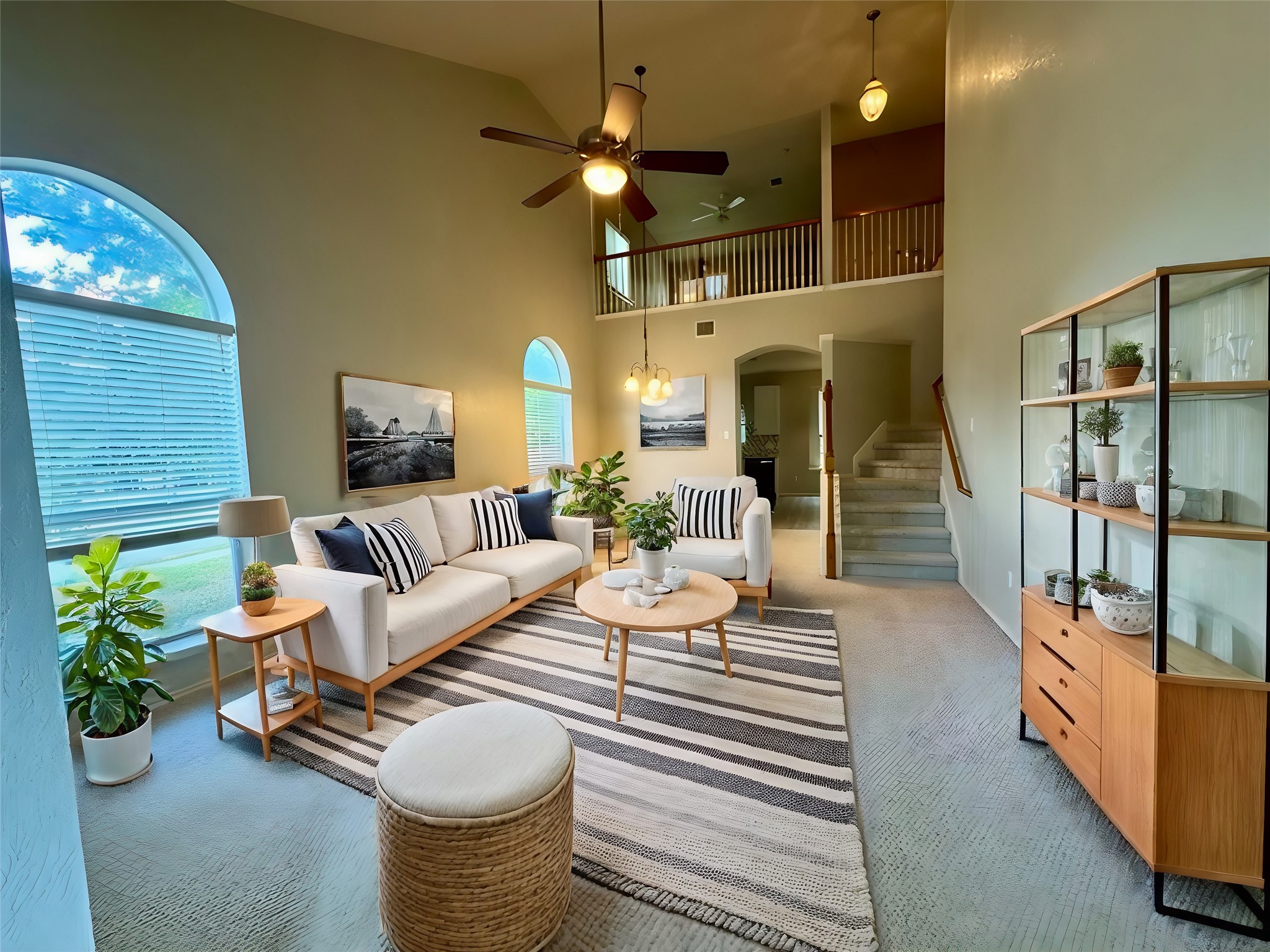 a living room with furniture a chandelier and a fireplace