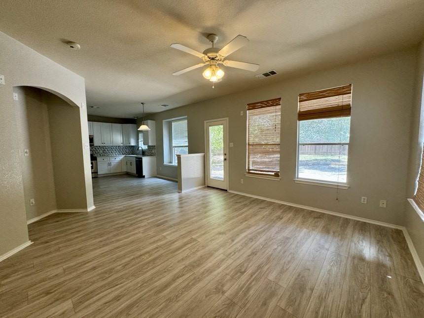 8301 Winterstein Drive Austin, TX 78745 - Photo 11 of 25 a view of an empty room with window and wooden floor