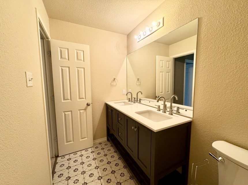 8301 Winterstein Drive Austin, TX 78745 - Photo 14 of 25 a bathroom with a sink and a mirror