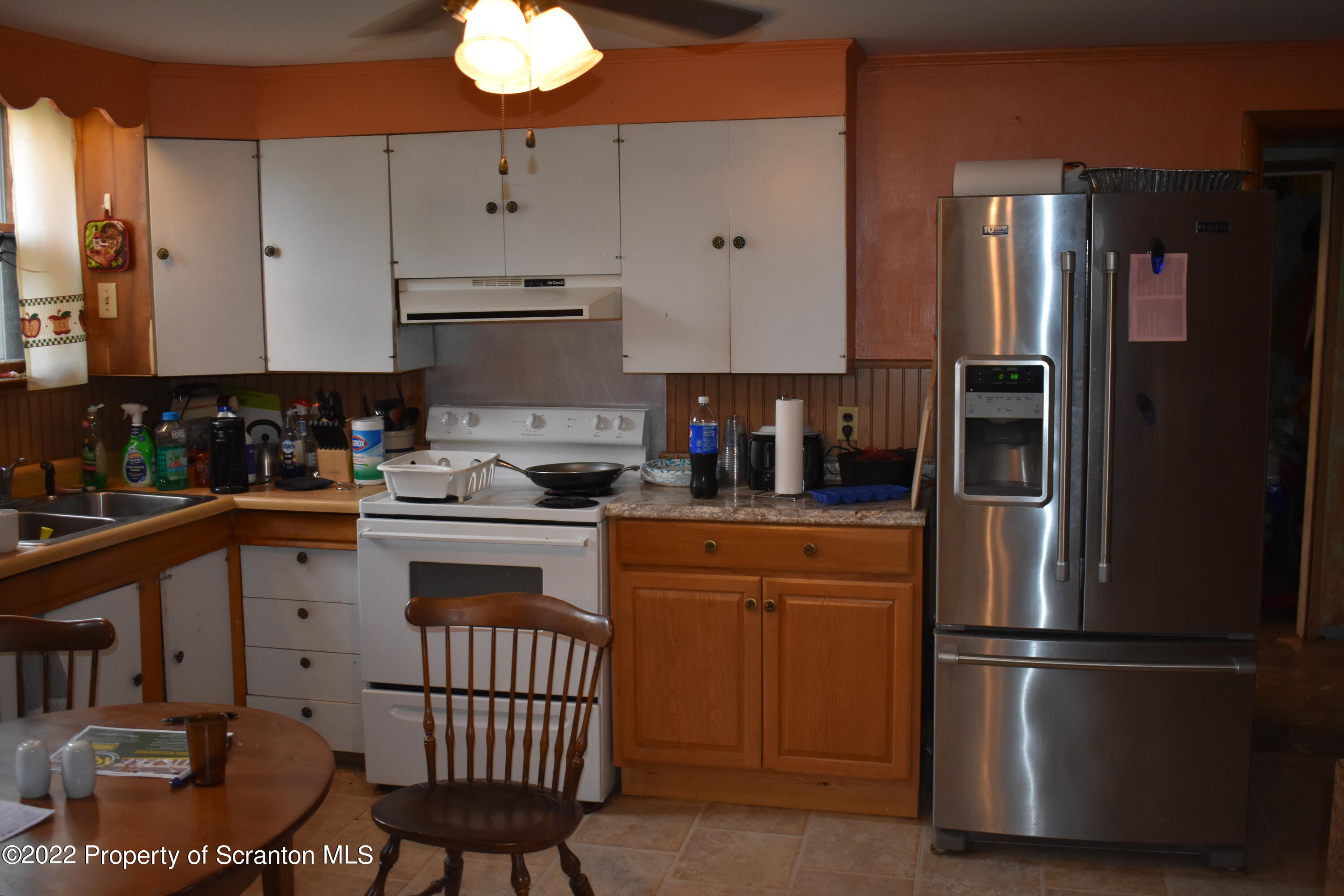 562 Main Street Great Bend, PA 18821 - Photo 3 of 31 a kitchen with stainless steel appliances granite countertop a refrigerator a stove a sink and a dining table