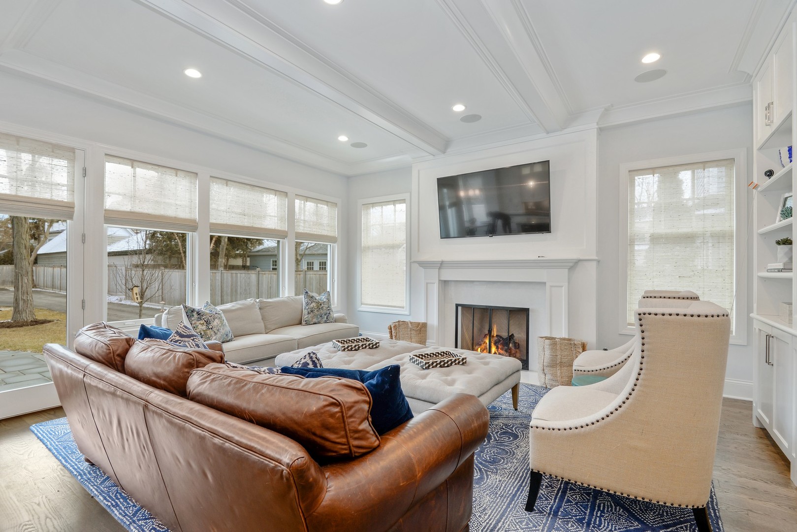 1003 Westmoor Road Winnetka, IL 60093 - Photo 12 of 38 a living room with furniture a fireplace and a flat screen tv