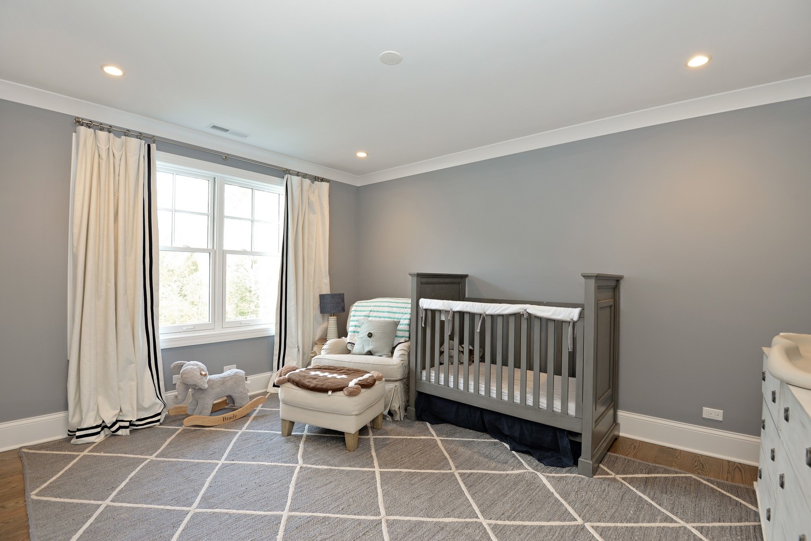 1003 Westmoor Road Winnetka, IL 60093 - Photo 20 of 38 a living room with a baby crib furniture and a window