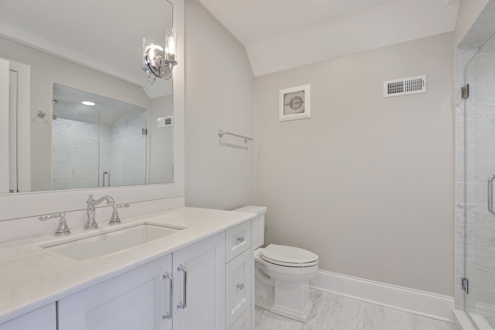 1003 Westmoor Road Winnetka, IL 60093 - Photo 23 of 38 a bathroom with a sink a toilet and a mirror