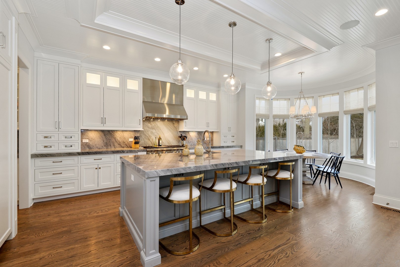 1003 Westmoor Road Winnetka, IL 60093 - Photo 10 of 38 a large kitchen with lots of counter space and dining table