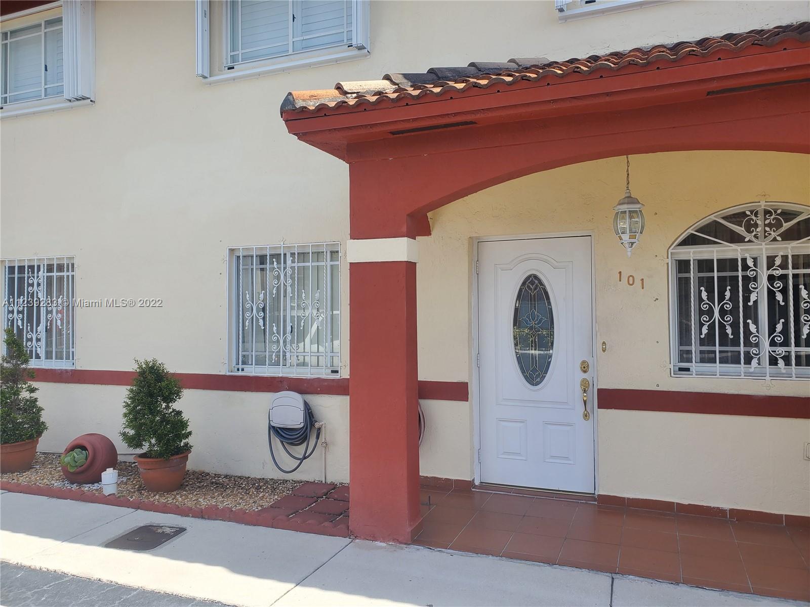 10953 West Okeechobee Road, Unit 101 Hialeah Gardens, FL 33018 - Photo 2 of 15 a front view of a house