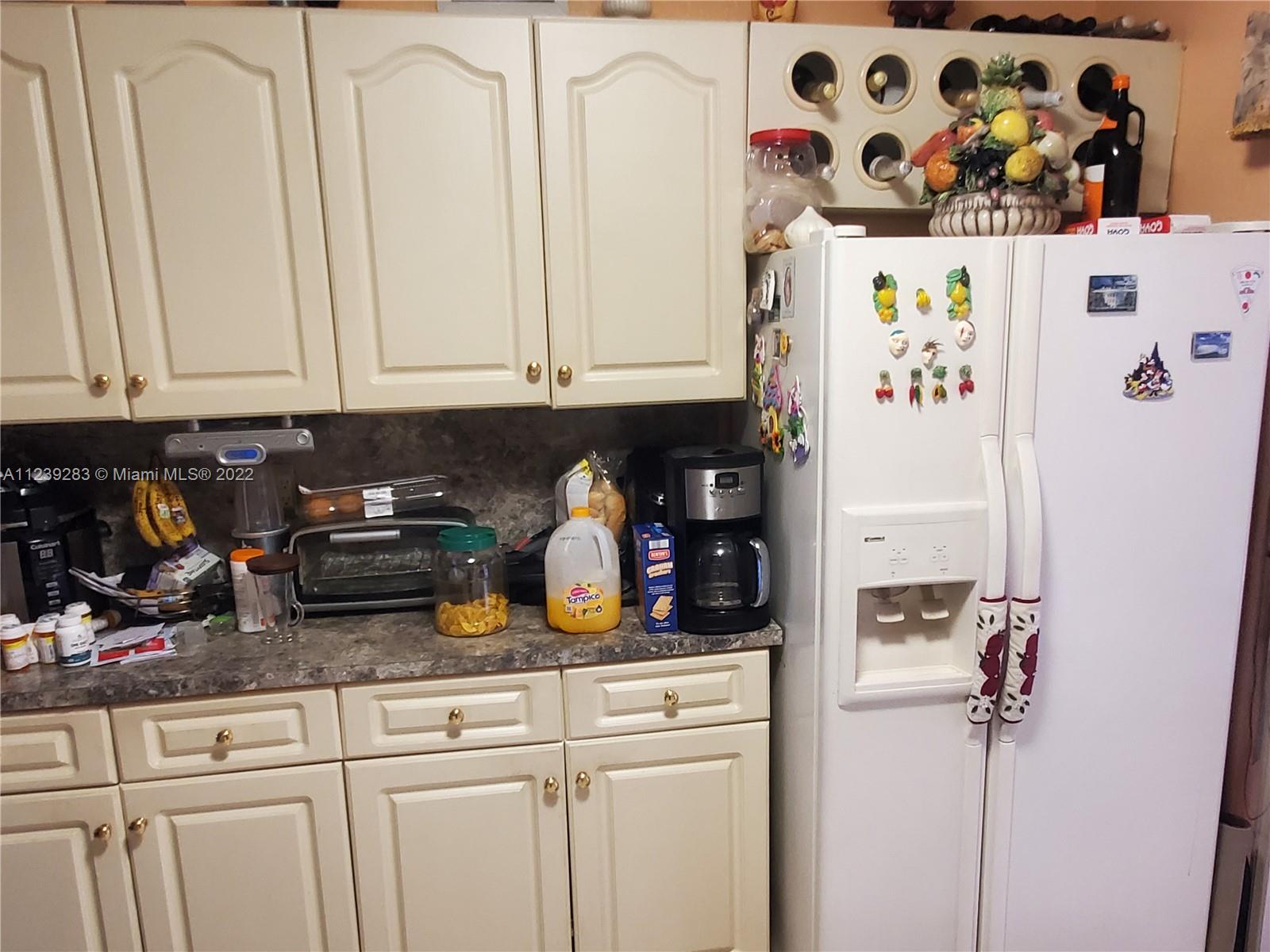 10953 West Okeechobee Road, Unit 101 Hialeah Gardens, FL 33018 - Photo 7 of 15 a kitchen with stainless steel appliances granite countertop a refrigerator and a cabinets