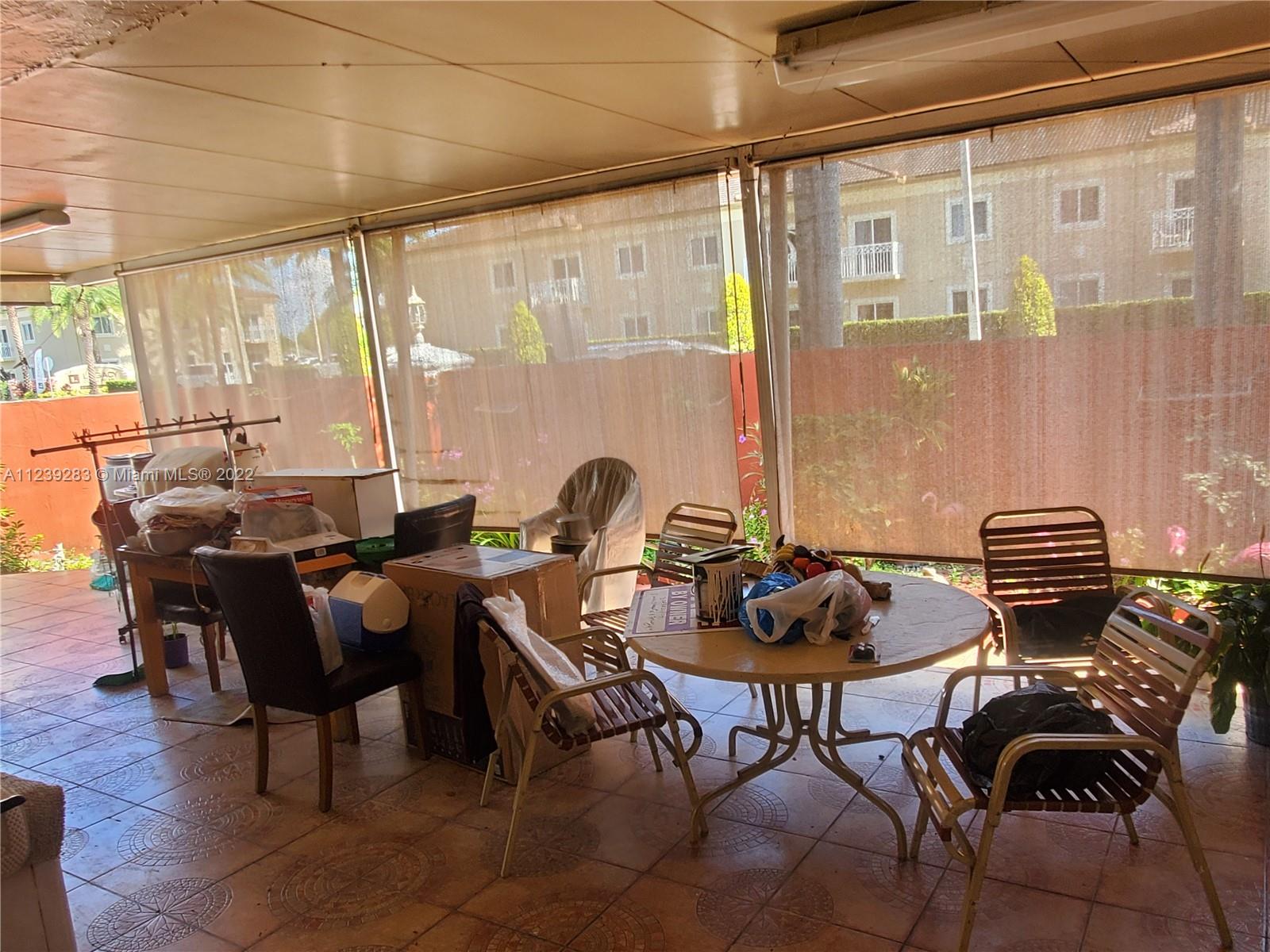 10953 West Okeechobee Road, Unit 101 Hialeah Gardens, FL 33018 - Photo 9 of 15 a dining room with furniture and wooden floor