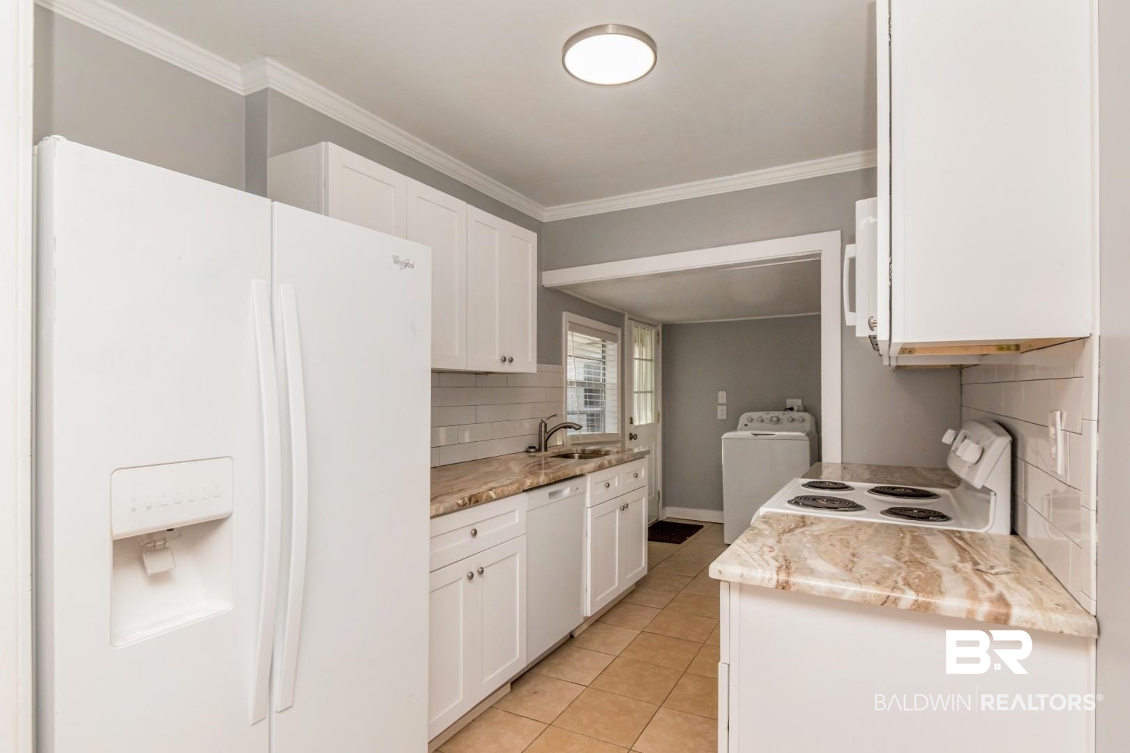 263 Border Drive East Mobile, AL 36608 - Photo 10 of 27 Kitchen featuring white cabinetry, light-toned countertops, a white subway tile backsplash, and tile flooring