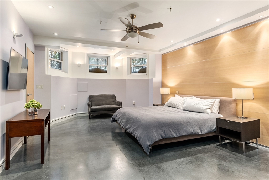37 Bay State Road, Unit 3 Boston, MA 02215 - Photo 9 of 18 a bedroom with a bed and a chandelier