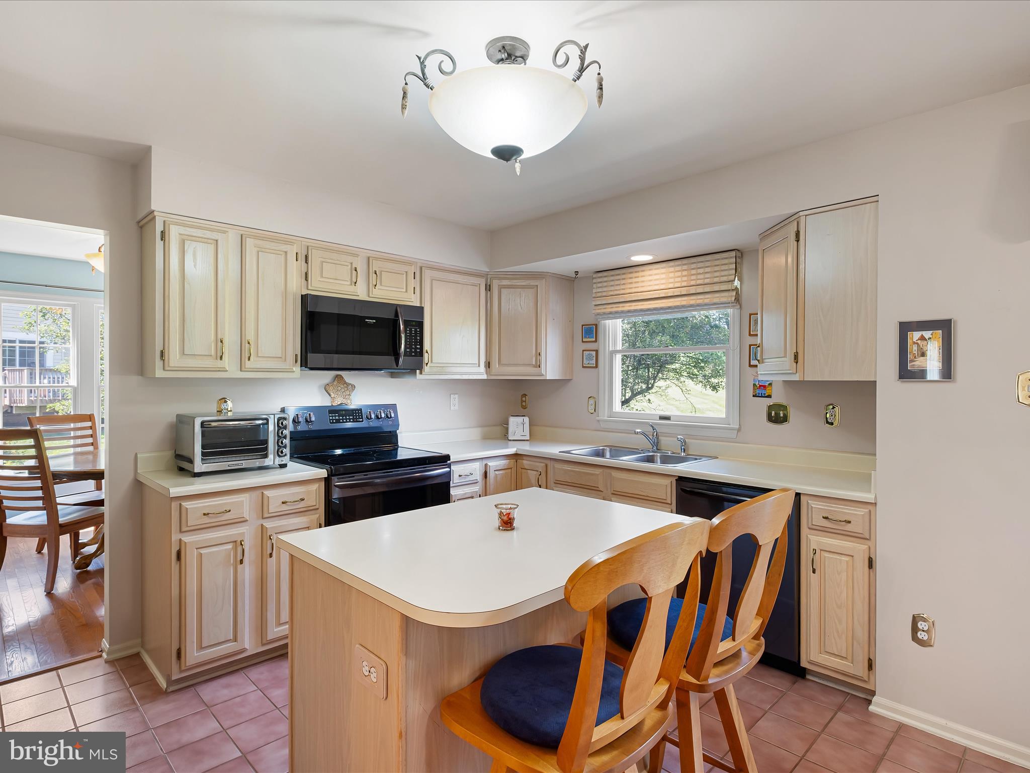 314 Edinburgh Road Chadds Ford, PA 19317 - Photo 14 of 29 a kitchen with a stove a sink dishwasher a dining table and chairs with wooden floor
