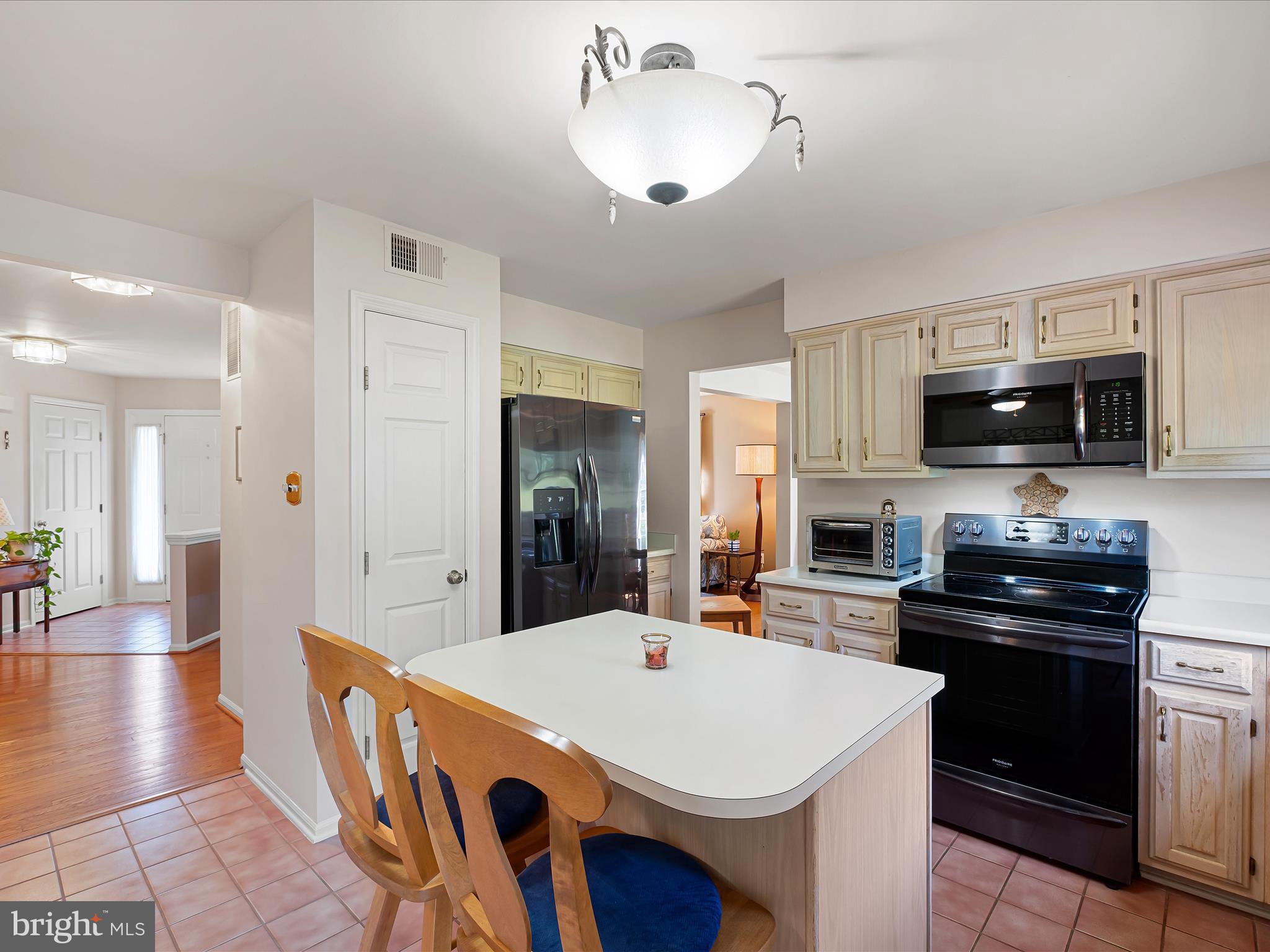 314 Edinburgh Road Chadds Ford, PA 19317 - Photo 15 of 29 a kitchen with stainless steel appliances a sink a stove a refrigerator cabinets and a dining table