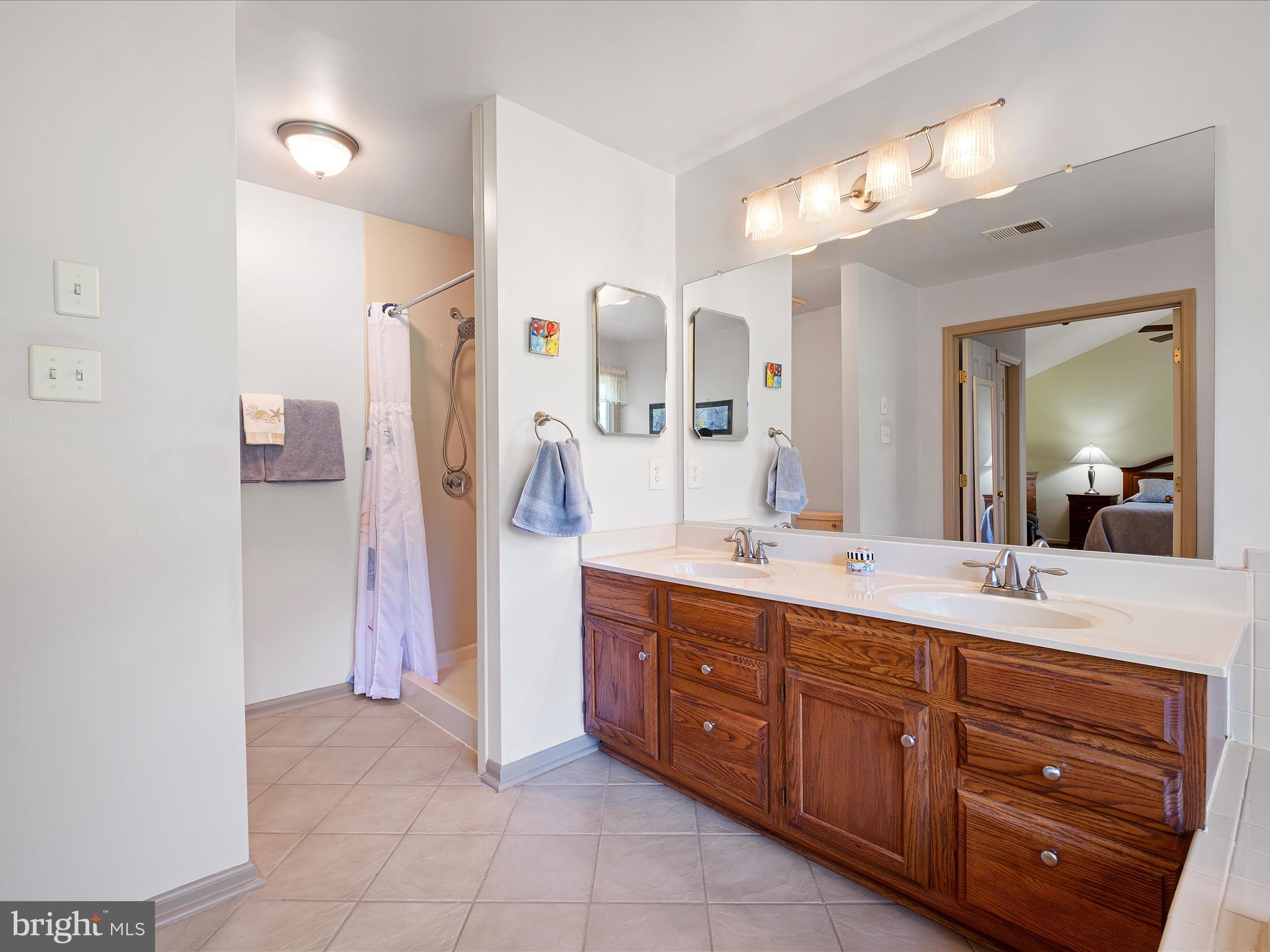 314 Edinburgh Road Chadds Ford, PA 19317 - Photo 26 of 29 a spacious bathroom with a double vanity sink mirror and double