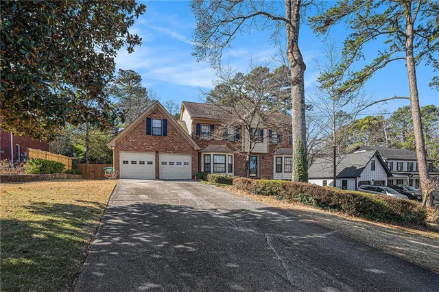 a front view of a house with a road