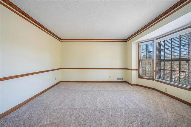 an empty room with a empty space and windows