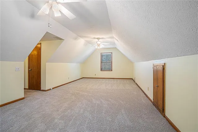 a bathroom with a granite countertop sink mirror vanity and toilet