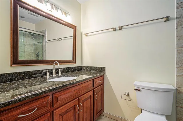 a bathroom with a toilet and a shower