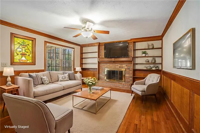a living room with furniture a fireplace and a flat screen tv