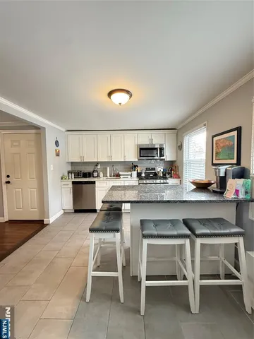 a kitchen with a sink cabinets and wooden floor