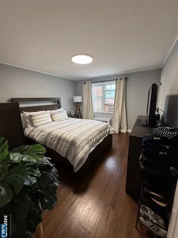 a bedroom with a bed window and dresser