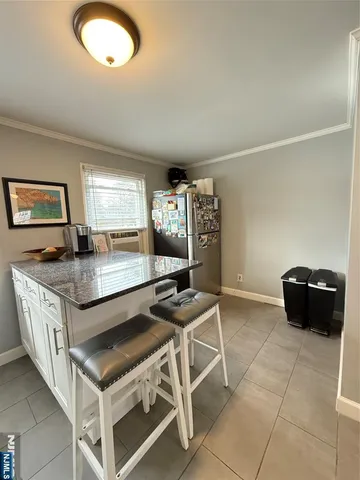 a kitchen with granite countertop a stove a sink and a granite counter top
