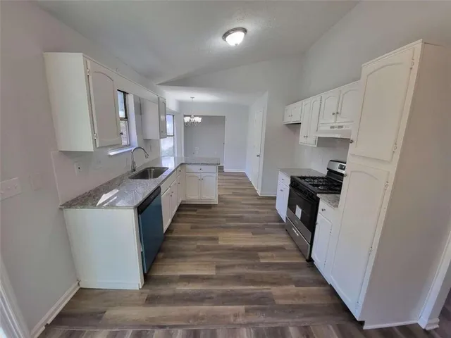 a kitchen with sink a stove and refrigerator