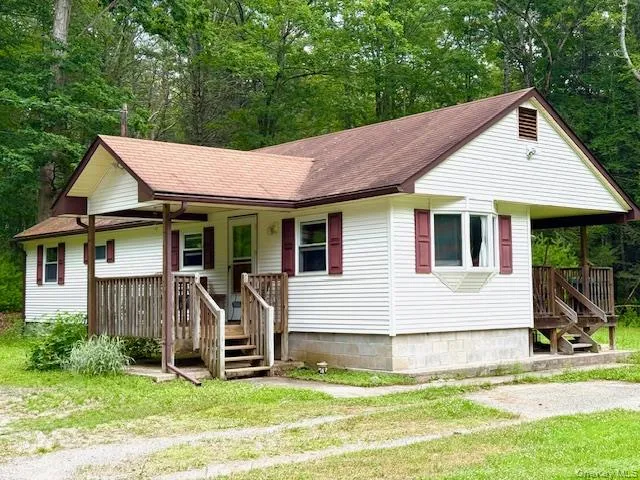 a view of a house with a yard patio and a garden
