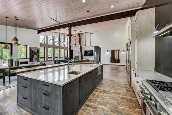 a kitchen with stainless steel appliances granite countertop a sink a stove and a refrigerator