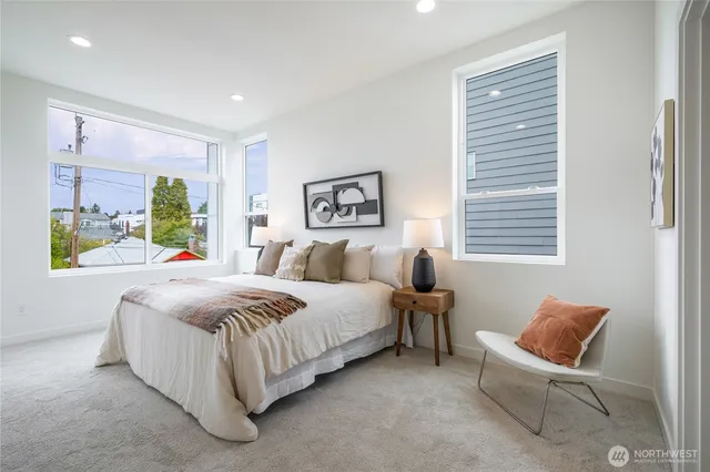 a bedroom with a bed and a painting on the wall