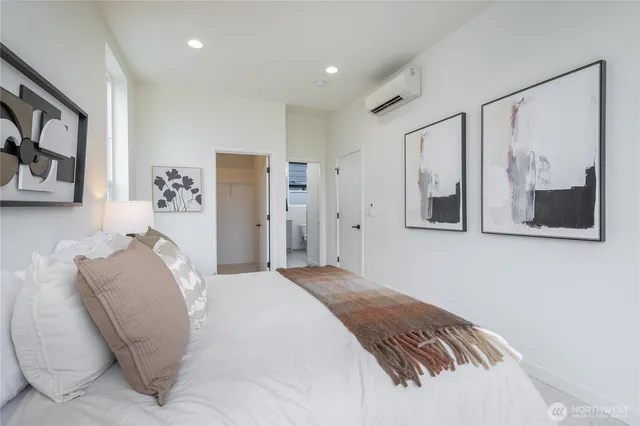 a bedroom with a bed and a painting on the wall