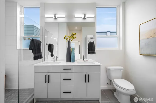 a bathroom with a toilet a sink and mirror