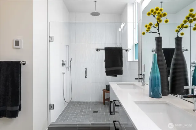 a bathroom with a sink a mirror and a shower