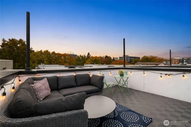 a balcony with furniture and a floor to ceiling window