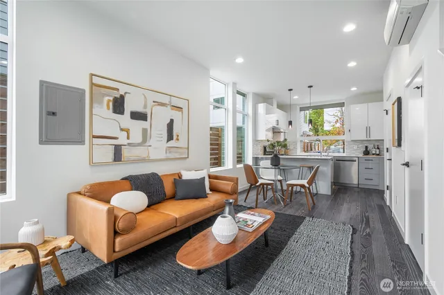 a living room with furniture kitchen and a table