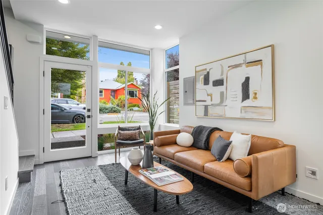 a living room with furniture and a wooden floor
