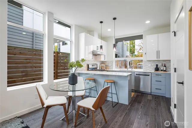 a kitchen with a table chairs stove and cabinets