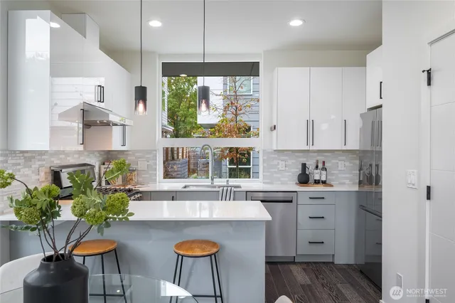 a kitchen with a table chairs stove and cabinets